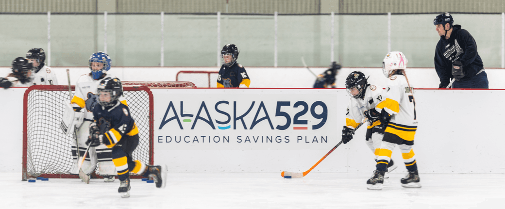 Players face off at center ice during a game at a community arena in Anchorage